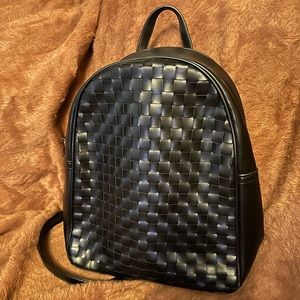 Backpack purse with crisscross pattern.
